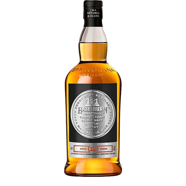 A clear glass rounded bottle of Hazelburn ten year old single malt scotch whisky, featuring a black and silver label.