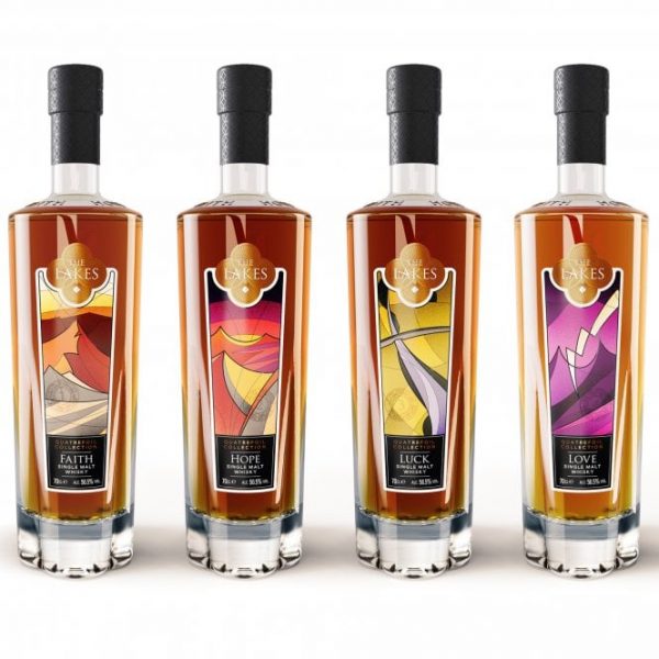 Four clear glass bottles of The Lakes Quatrefoil Single Malt Whisky Collection each featuring a label with a different abstract pattern