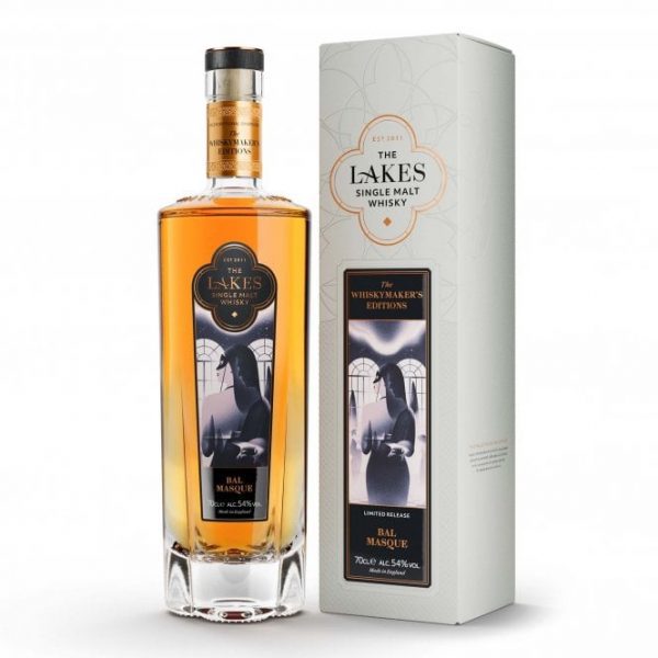 A clear glass bottle of The Lakes Bal Masque Whiskymaker's Edition Single Malt Whisky and ivory presentation box with gold detailing